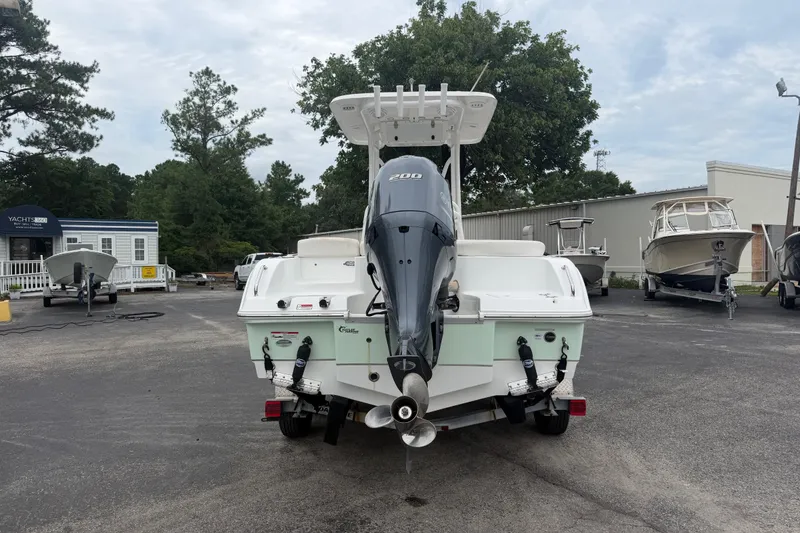 Slide: The Image of 2022 Sea Hunt Ultra 219 boat with outboard motor in a marina setting. - 4