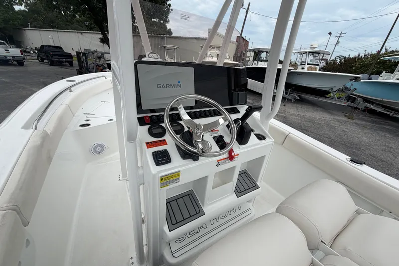 Slide: The Image of 2022 Sea Hunt Ultra 219 boat dashboard with Garmin navigation system and steering wheel. - 9