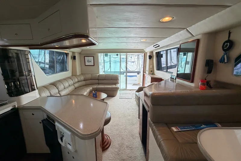 Slide: The Image of Luxurious interior of a 1997 Sea Ray 550 Sedan Bridge yacht with plush seating and modern amenities. - 42