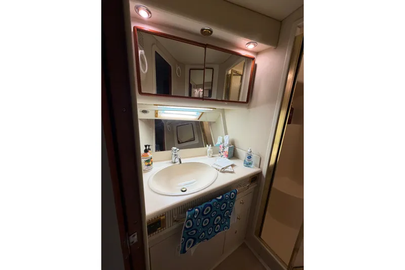 Slide: The Image of Bathroom vanity in 1997 Sea Ray 550 Sedan Bridge yacht, featuring sink and mirror. - 41