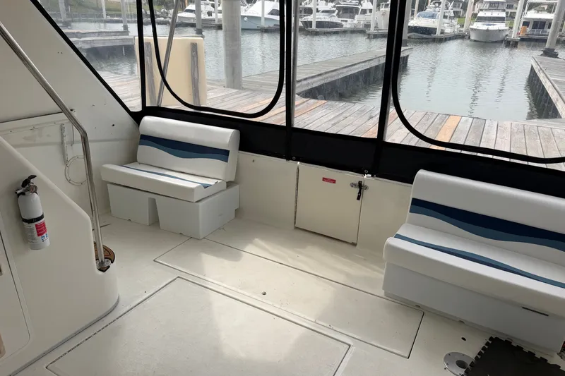 Slide: The Image of Interior of 1997 Sea Ray 550 Sedan Bridge yacht with seating and marina view. - 21