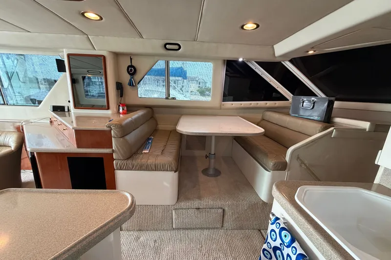 Slide: The Image of Luxurious interior of a 1997 Sea Ray 550 Sedan Bridge yacht with dining area. - 29