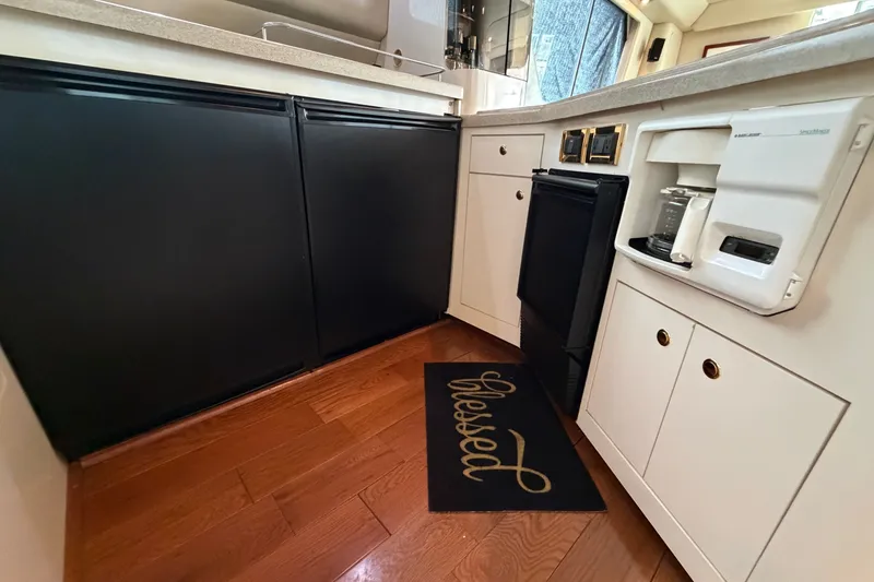 Slide: The Image of Interior of 1997 Sea Ray 550 Sedan Bridge yacht kitchen with wood flooring and appliances. - 43