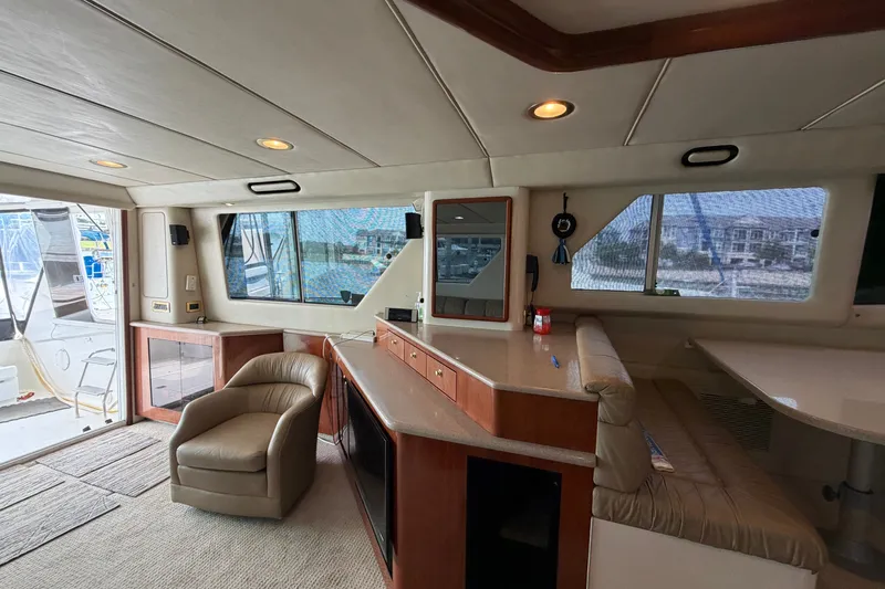 Slide: The Image of Luxurious interior of 1997 Sea Ray 550 Sedan Bridge yacht with leather seating and panoramic windows. - 44