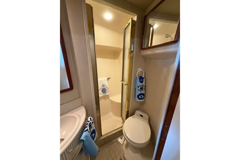 Slide: The Image of Bathroom interior of 1997 Sea Ray 550 Sedan Bridge yacht with shower and toilet. - 34