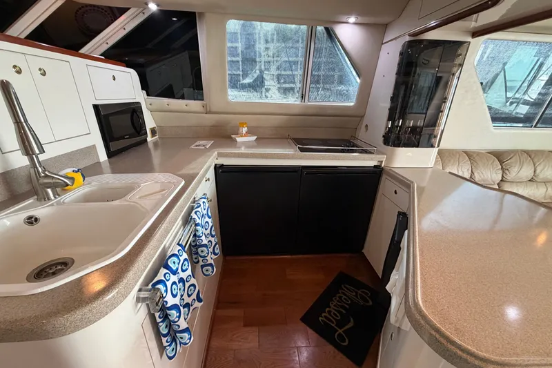Slide: The Image of Luxurious kitchen interior of 1997 Sea Ray 550 Sedan Bridge yacht with modern amenities. - 27