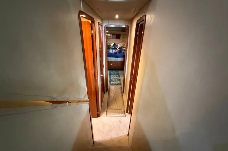 Slide: The Image of Interior hallway of a 1997 Sea Ray 550 Sedan Bridge yacht, leading to a bedroom. - 30