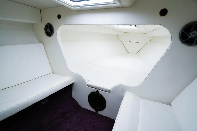 Slide: The Image of Interior of 2000 Active Thunder 32 boat with white seating and speakers. - 15
