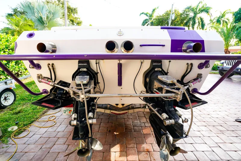Slide: The Image of Rear view of a 2000 Active Thunder 32 boat with dual Mercury engines. - 20