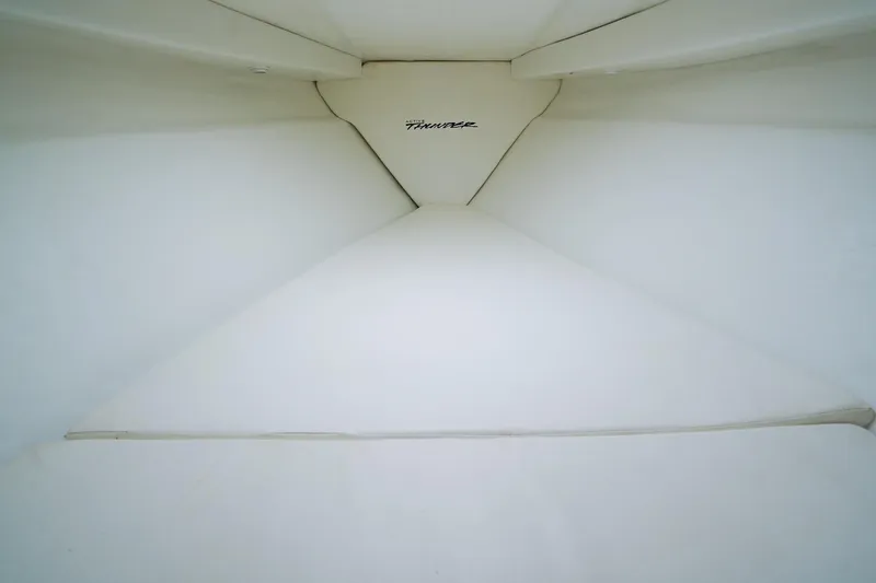 Slide: The Image of Interior view of 2000 Active Thunder 32 boat cabin, featuring white upholstery. - 16