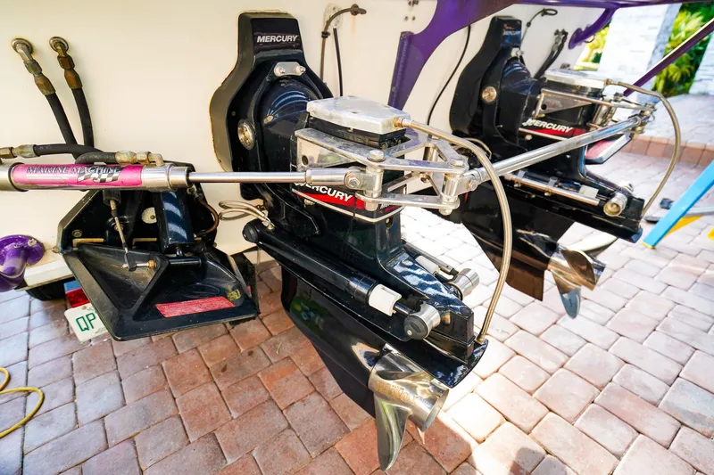 Slide: The Image of Twin Mercury outboard engines on a 2000 Active Thunder 32 boat, displayed on a brick surface. - 22
