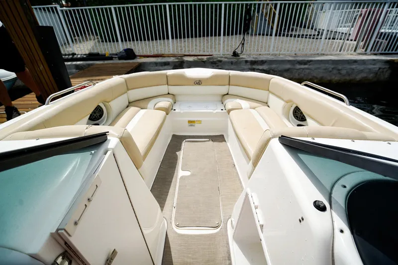 Slide: The Image of 2017 NauticStar 243DC Sport Deck boat interior with beige seating and spacious layout. - 17