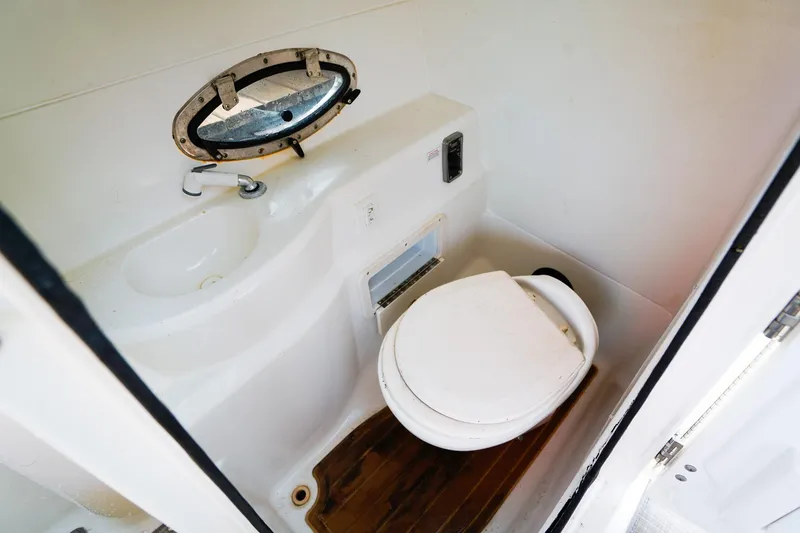 Slide: The Image of 2017 NauticStar 243DC Sport Deck boat bathroom with sink and toilet. - 15