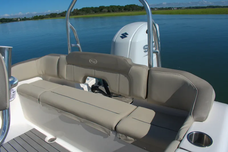 Slide: The Image of 2024 Key West 203 FS boat with comfortable seating and Suzuki outboard motor on calm water. - 12