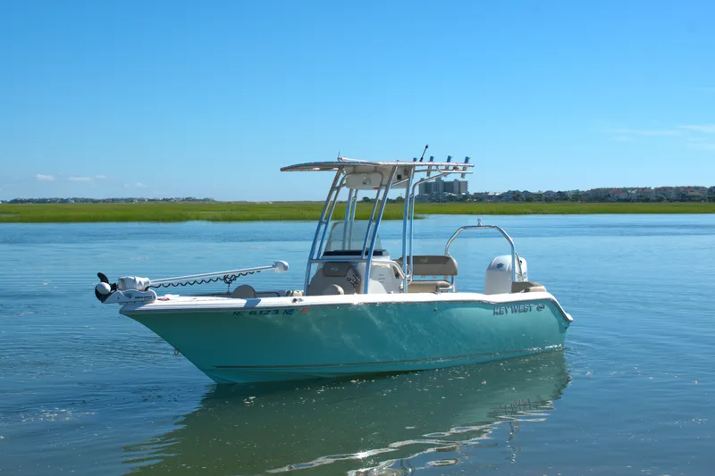 The Image of 2024 Key West 203 FS boat on calm water under clear blue sky. - 0