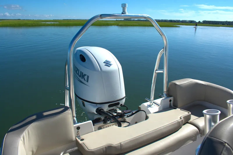 Slide: The Image of 2024 Key West 203 FS boat with Suzuki outboard motor on calm water. - 8