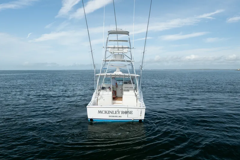 Slide: The Image of 2011 Cabo 36 Express boat on open water, rear view with tower and clear sky. - 13