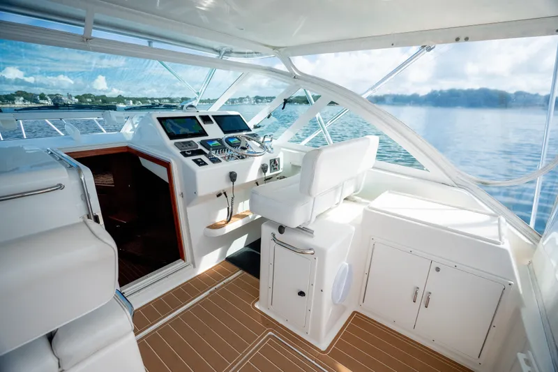 Slide: The Image of Interior view of 2011 Cabo 36 Express yacht cockpit with modern controls and seating. - 33