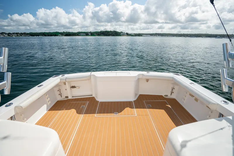 Slide: The Image of 2011 Cabo 36 Express boat deck overlooking serene water and cloudy sky. - 22