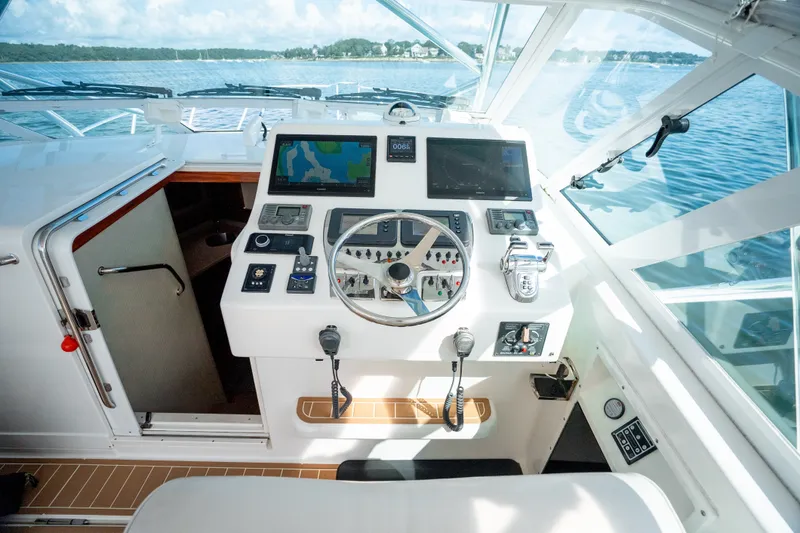 Slide: The Image of Helm of 2011 Cabo 36 Express boat with navigation equipment and steering wheel. - 34