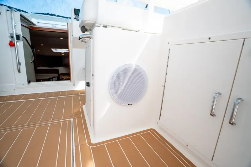 Slide: The Image of Interior view of 2011 Cabo 36 Express boat with teak flooring and cabin entrance. - 32