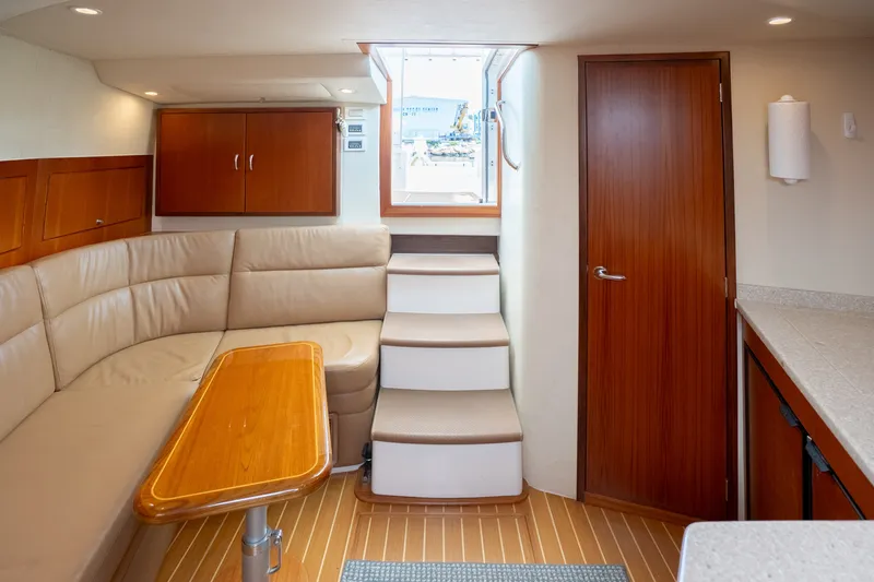 Slide: The Image of Interior of 2011 Cabo 36 Express yacht with beige seating and wooden accents. - 39