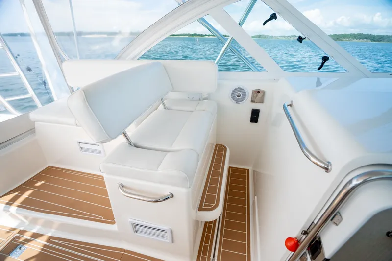 Slide: The Image of Interior of 2011 Cabo 36 Express boat with white seating and ocean view. - 35