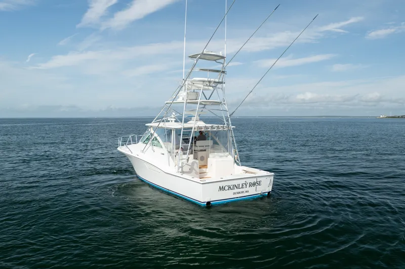 Slide: The Image of 2011 Cabo 36 Express boat on open water under a clear sky. - 14