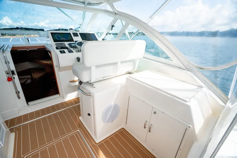 Slide: The Image of 2011 Cabo 36 Express yacht interior with helm, seating, and ocean view. - 31