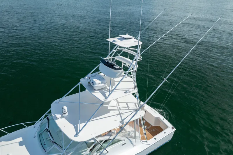 Slide: The Image of 2011 Cabo 36 Express boat with tower on calm water. - 17