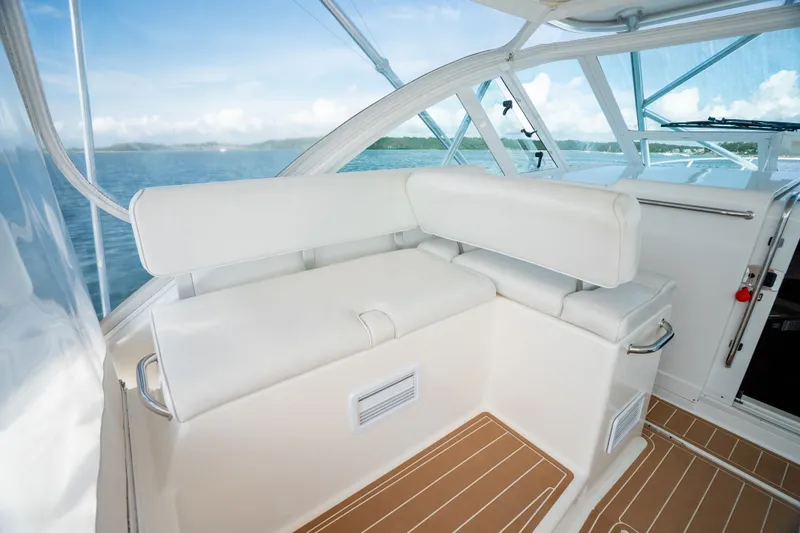 Slide: The Image of 2011 Cabo 36 Express boat interior with white seating and ocean view. - 30
