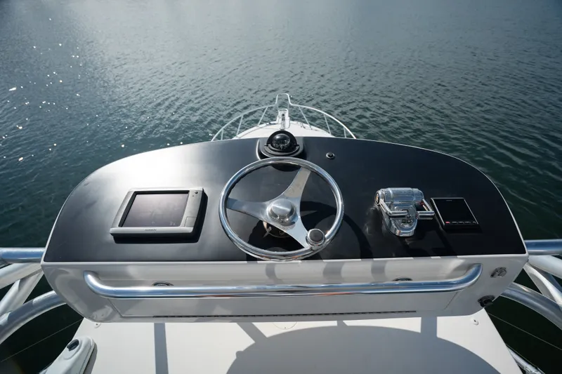 Slide: The Image of Helm of 2011 Cabo 36 Express boat with steering wheel and controls. - 18