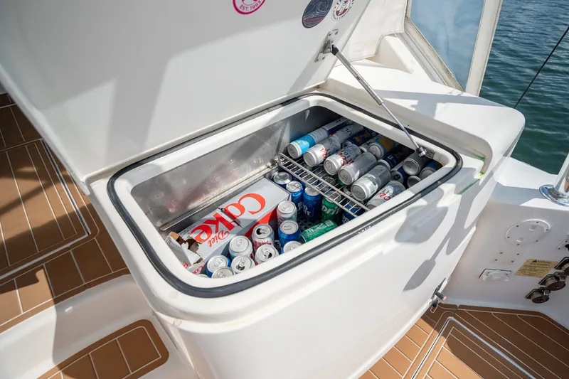 Slide: The Image of Open cooler on 2011 Cabo 36 Express boat, filled with assorted beverage cans. - 27