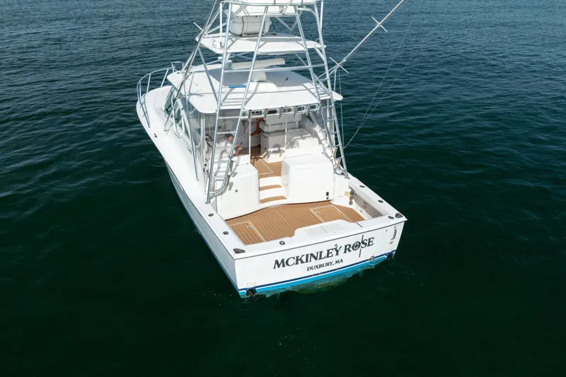 Slide: The Image of 2011 Cabo 36 Express boat on water, rear view, named "McKinley Rose." - 16