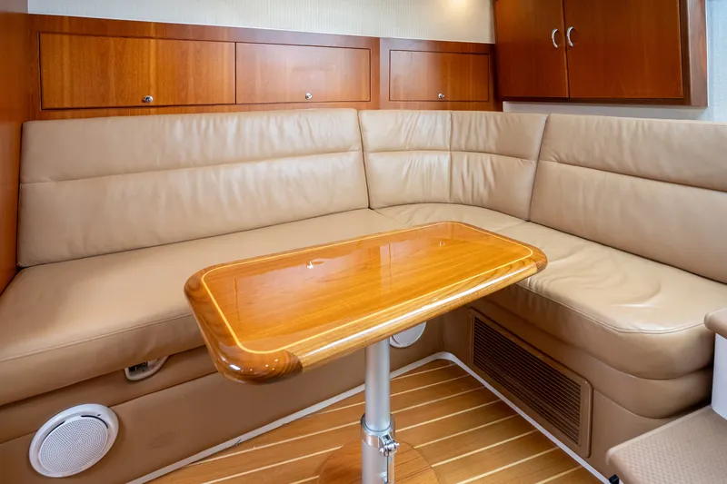 Slide: The Image of Luxurious interior of 2011 Cabo 36 Express yacht with leather seating and wooden table. - 40