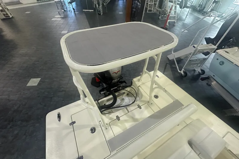 Slide: The Image of 2024 Hewes Redfisher 16 boat with elevated platform and outboard motor in showroom. - 14