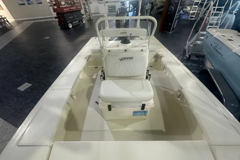 Slide: The Image of 2024 Hewes Redfisher 16 boat interior with seating and console, displayed indoors. - 8