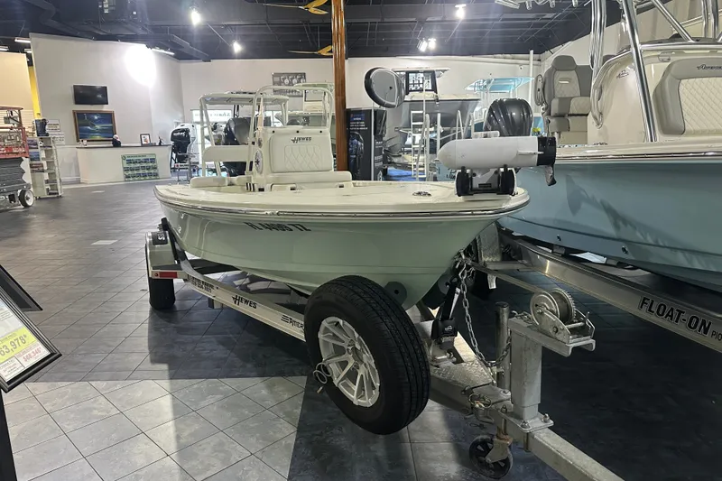 Slide: The Image of 2024 Hewes Redfisher 16 boat displayed in showroom on trailer. - 1