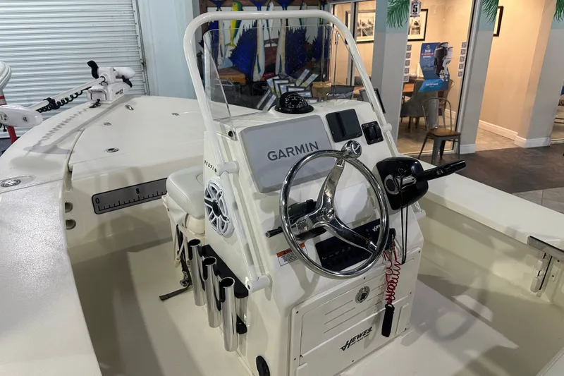 Slide: The Image of 2024 Hewes Redfisher 16 boat interior with Garmin navigation system and steering wheel. - 15