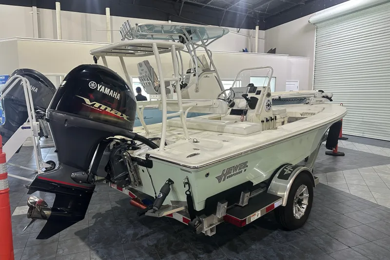 Slide: The Image of 2024 Hewes Redfisher 16 boat with Yamaha VMAX engine in showroom. - 5