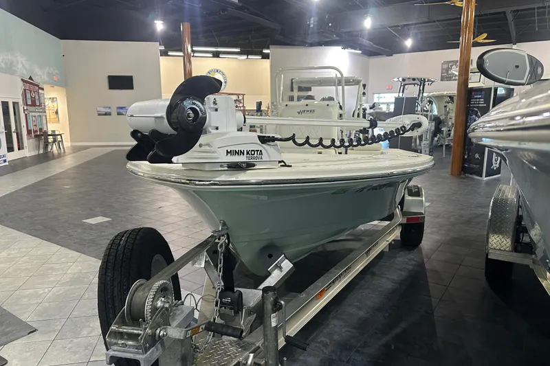 Slide: The Image of 2024 Hewes Redfisher 16 boat with Minn Kota Terrova motor on display indoors. - 2