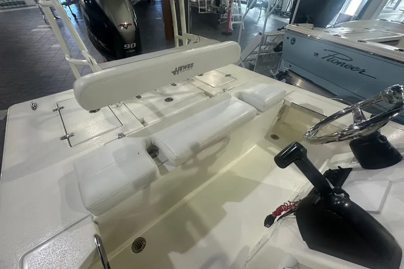 Slide: The Image of 2024 Hewes Redfisher 16 boat interior with steering wheel and seating. - 9