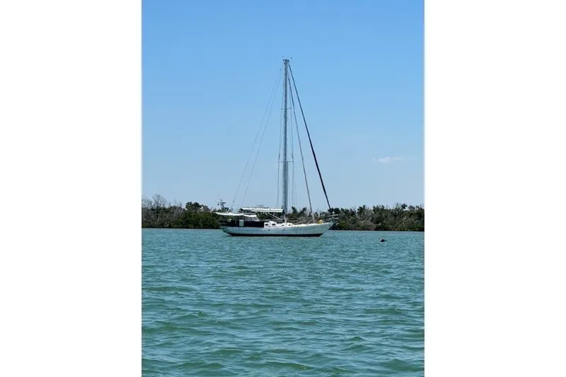 Slide: The Image of Sailboat on calm water, Reliance 44 model, 2011, under clear blue sky. - 59
