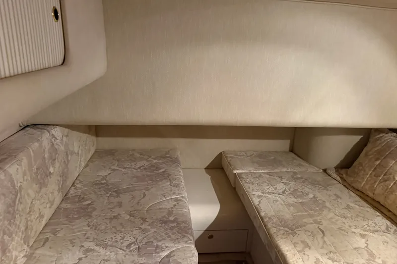 Slide: The Image of Interior cabin of 1997 Sea Ray 400 Sedan Bridge with twin beds and beige decor. - 6