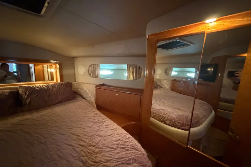 Slide: The Image of Luxurious bedroom interior of 1997 Sea Ray 400 Sedan Bridge yacht with mirrored closet. - 24