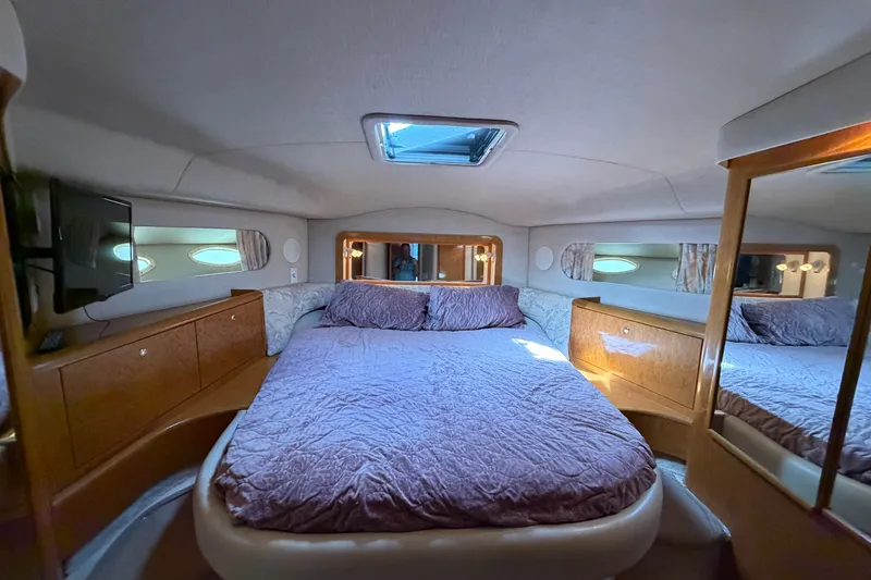 Slide: The Image of Luxurious bedroom interior of 1997 Sea Ray 400 Sedan Bridge yacht with cozy bedding. - 9