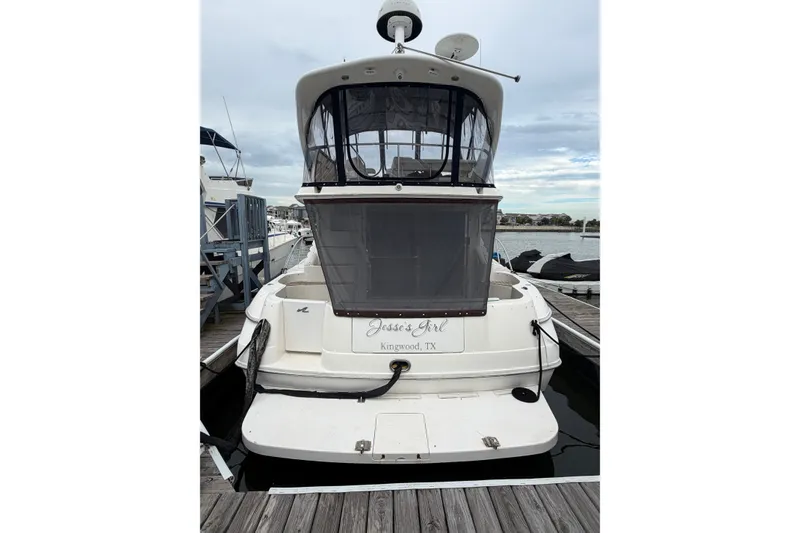 Slide: The Image of 1997 Sea Ray 400 Sedan Bridge docked at marina, rear view. - 4