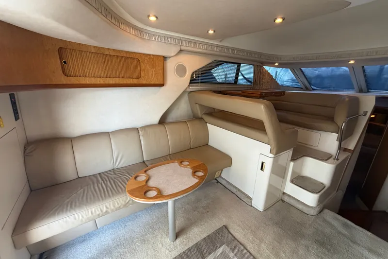 Slide: The Image of Luxurious interior of a 1997 Sea Ray 400 Sedan Bridge yacht with beige seating. - 12