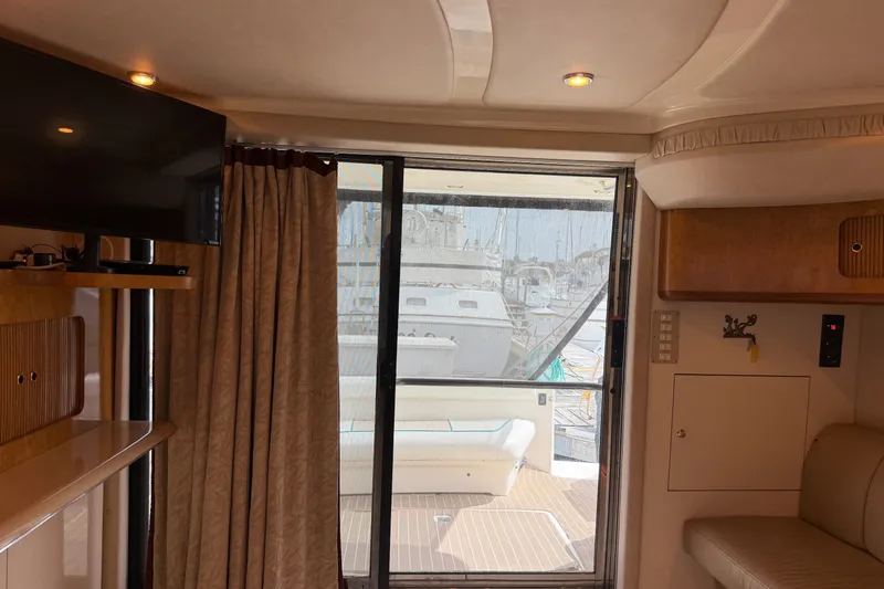 Slide: The Image of Interior view of 1997 Sea Ray 400 Sedan Bridge yacht with sliding glass door. - 5