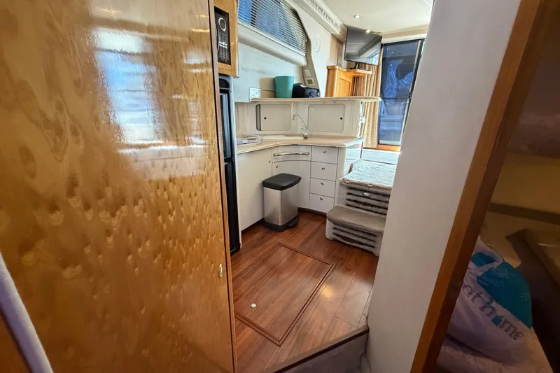 Slide: The Image of Interior of 1997 Sea Ray 400 Sedan Bridge yacht with kitchen and stairs. - 26